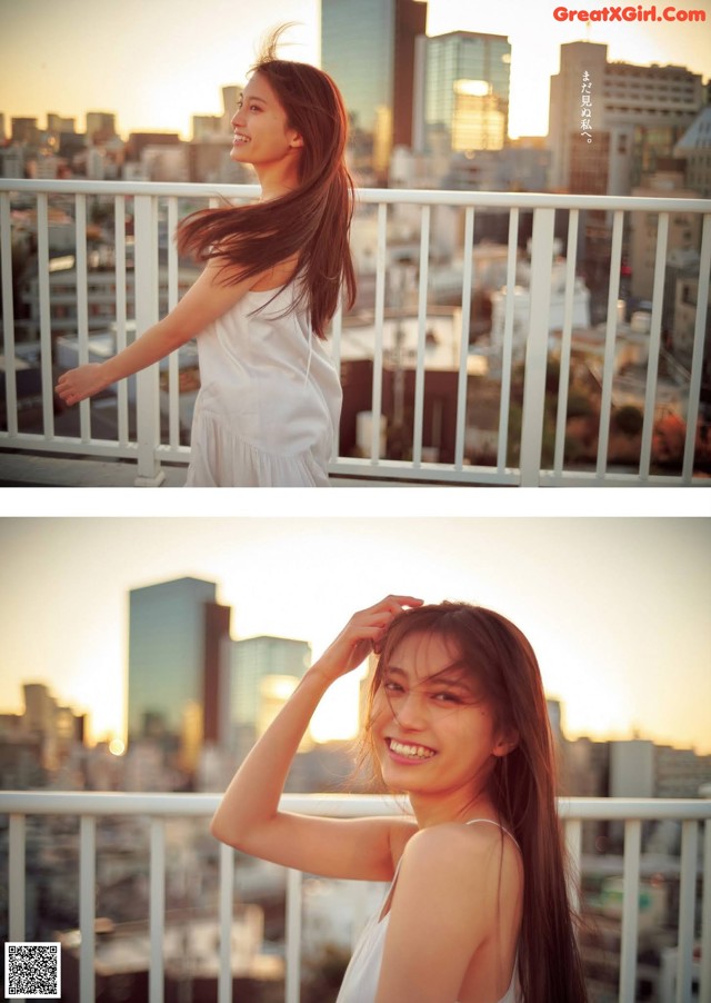 A woman in a white dress standing on a balcony.