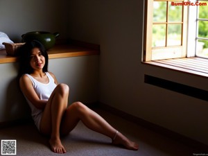 A woman in a colorful shirt is looking out of a window.