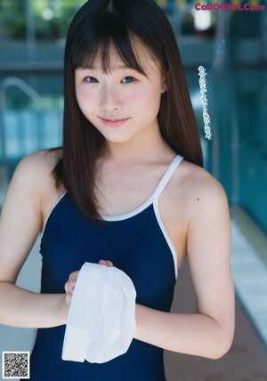 A young woman in a school uniform is posing for a picture.