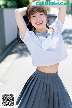 A young girl laying on top of a bed in pajamas.