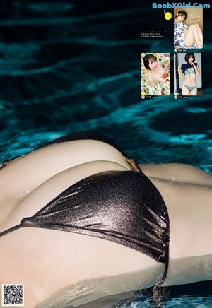 A woman in a bikini standing in a pool.