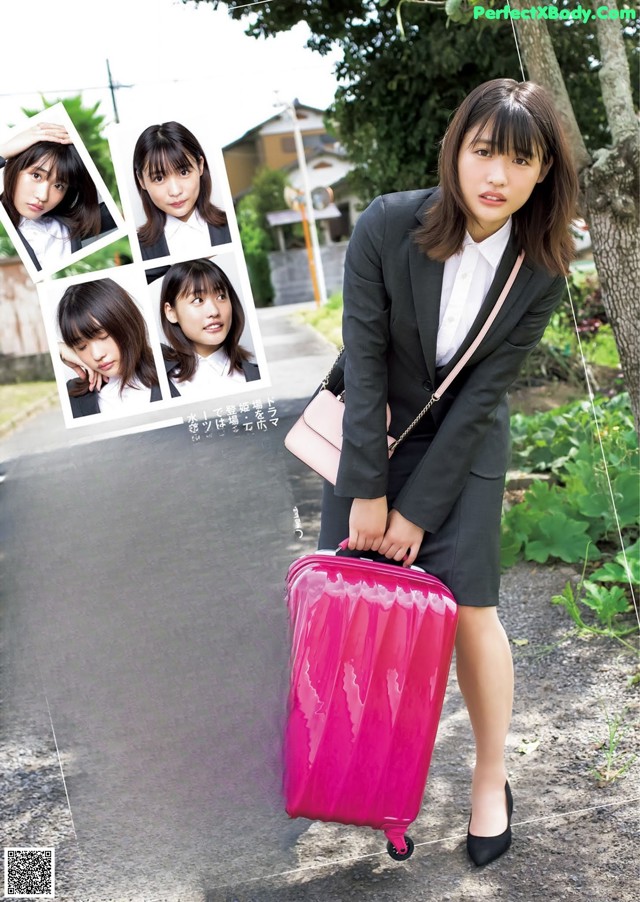 A woman in a business suit holding a pink suitcase.