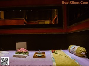A couple of women sitting on top of a bed next to each other.