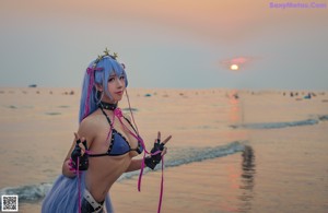 A woman with long purple hair and a crown on her head.