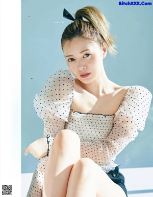 A woman sitting on top of a white table.