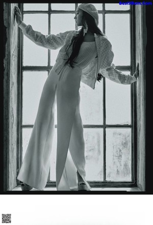 A woman standing on the stairs of a building.