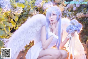 A woman with long blue hair wearing a white dress and a flower crown.