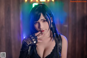 A woman in lingerie posing in front of a bar.