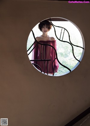 A woman sticking out her tongue in front of a mirror.